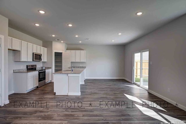 kitchen featuring a center island with sink, white cabinets, light stone counters, dark hardwood / wood-style flooring, and stainless steel appliances