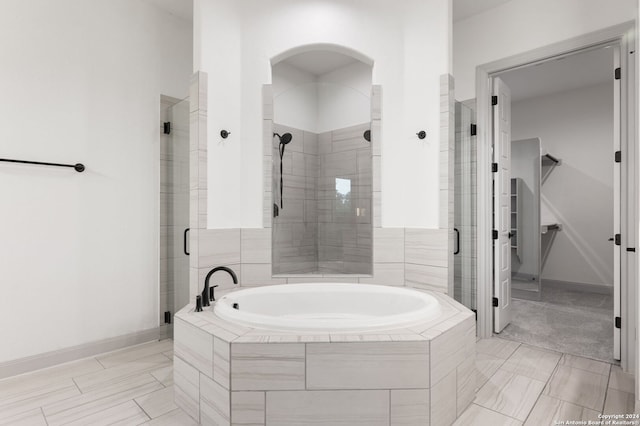 bathroom with shower with separate bathtub and tile patterned flooring