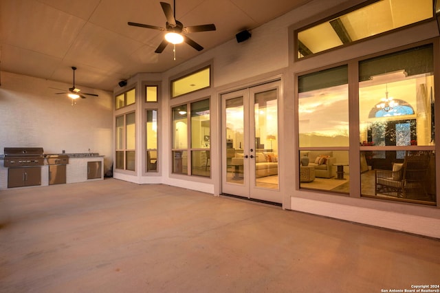 view of patio featuring ceiling fan, area for grilling, french doors, and exterior kitchen