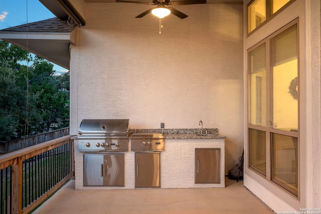 view of patio / terrace featuring ceiling fan, an outdoor kitchen, sink, and a grill