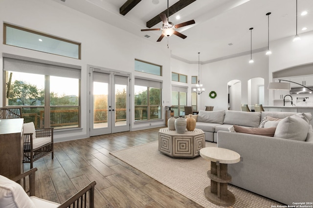 living room featuring hardwood / wood-style floors, french doors, a high ceiling, and ceiling fan