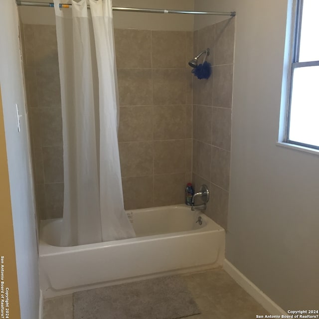 bathroom with shower / bath combination with curtain and tile patterned floors