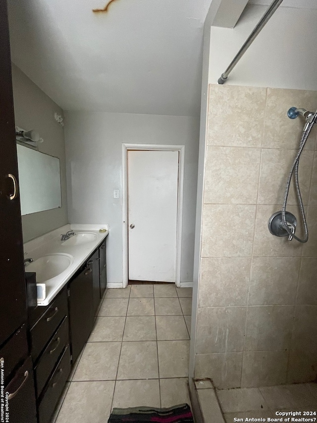 bathroom with tile patterned floors, vanity, and tiled shower