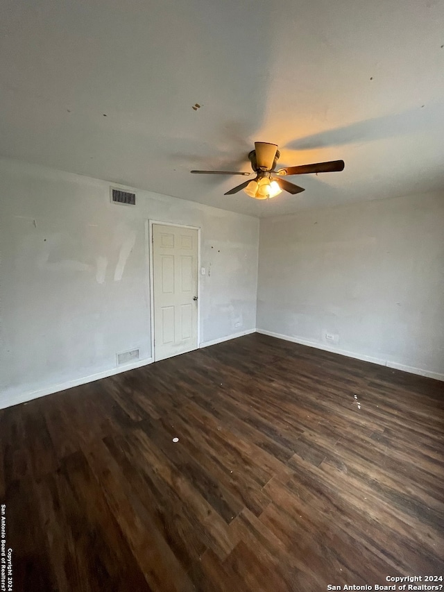 unfurnished bedroom featuring dark hardwood / wood-style flooring and ceiling fan