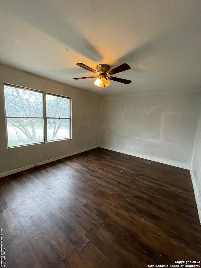 spare room featuring ceiling fan and dark hardwood / wood-style flooring