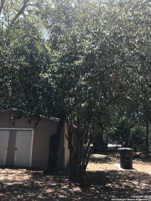 view of side of home with a shed