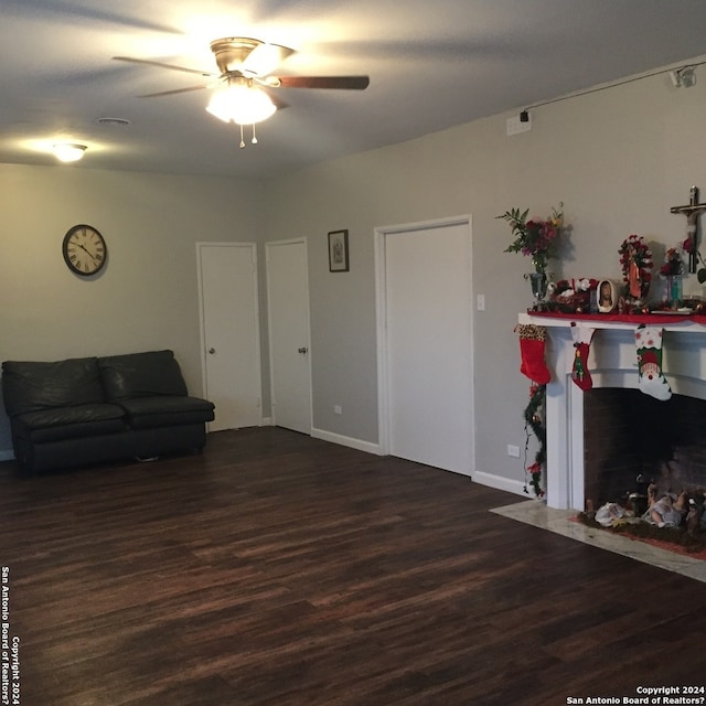 living room featuring ceiling fan and wood-type flooring