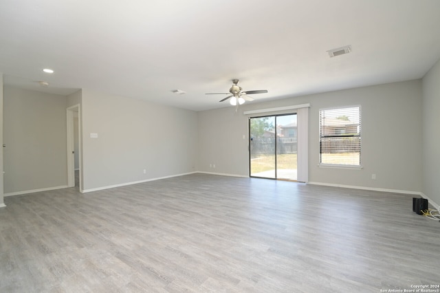 empty room with light hardwood / wood-style floors and ceiling fan