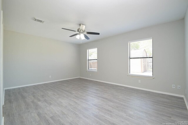 unfurnished room with ceiling fan and wood-type flooring