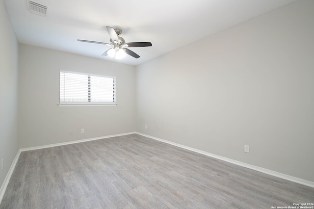 unfurnished room featuring ceiling fan and hardwood / wood-style flooring