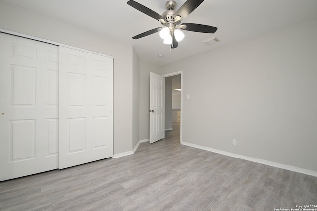 unfurnished bedroom with a closet, ceiling fan, and light wood-type flooring