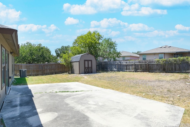 view of yard featuring a patio area and a storage unit