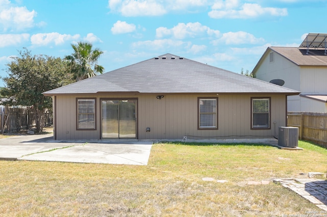 back of property featuring central air condition unit, a patio area, and a lawn