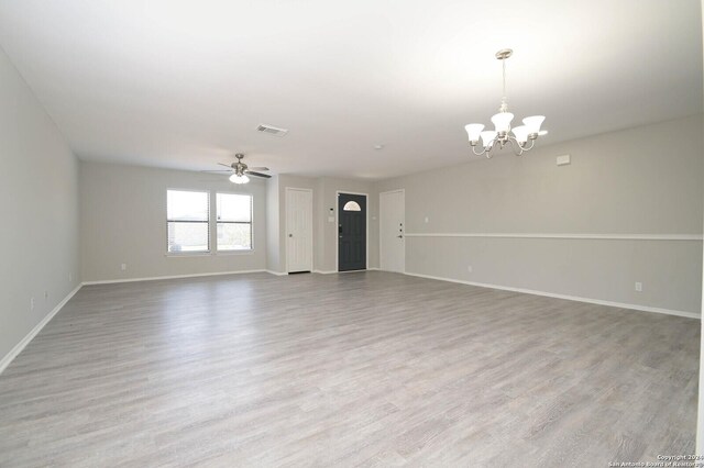 unfurnished living room with light hardwood / wood-style flooring and ceiling fan with notable chandelier