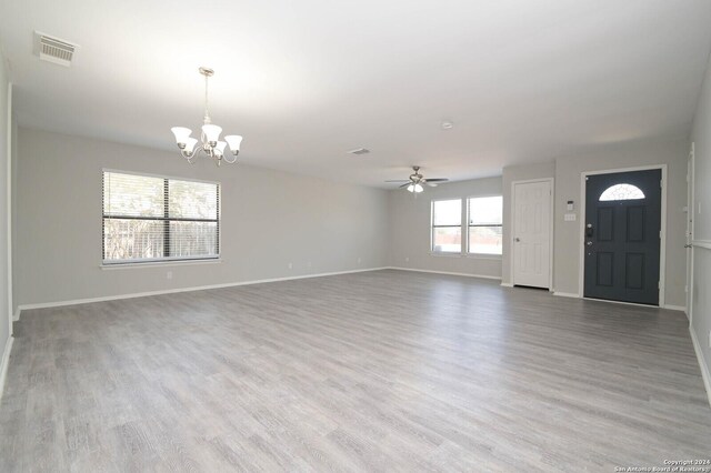 foyer featuring ceiling fan with notable chandelier and hardwood / wood-style floors