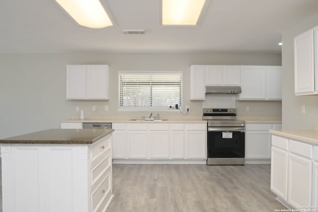 kitchen with appliances with stainless steel finishes, light hardwood / wood-style flooring, white cabinetry, and sink