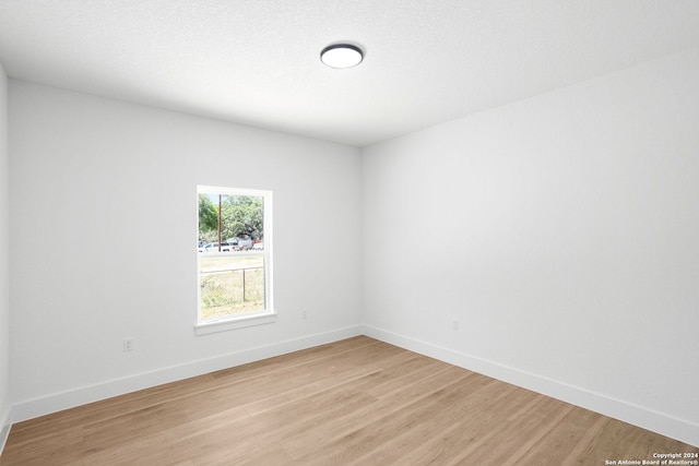 unfurnished room with light wood-type flooring