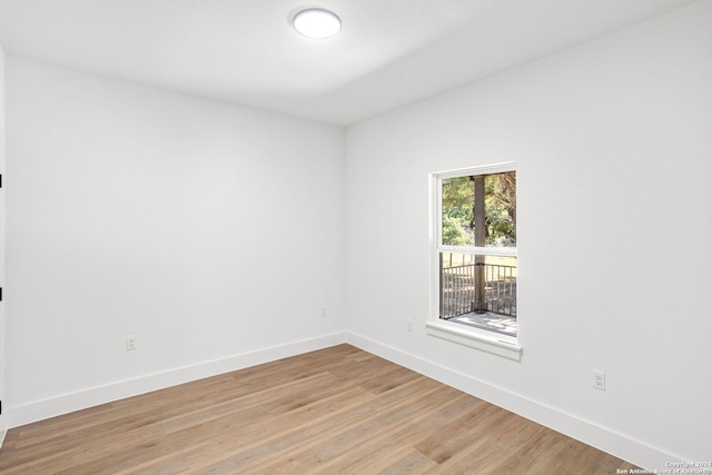 spare room with light wood-type flooring