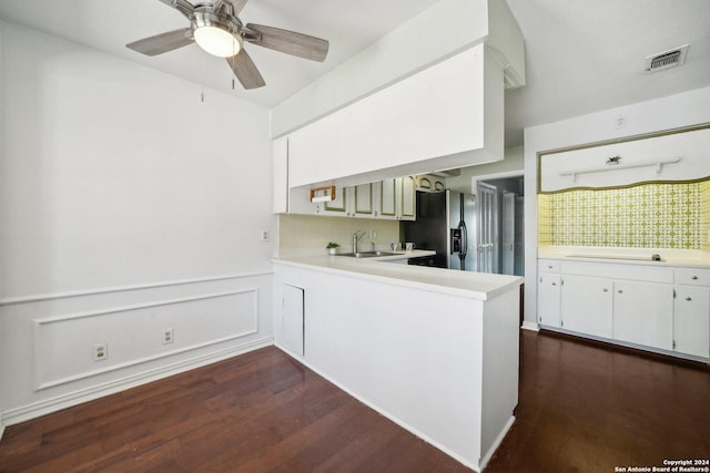 kitchen featuring a peninsula, visible vents, white cabinets, light countertops, and stainless steel fridge with ice dispenser