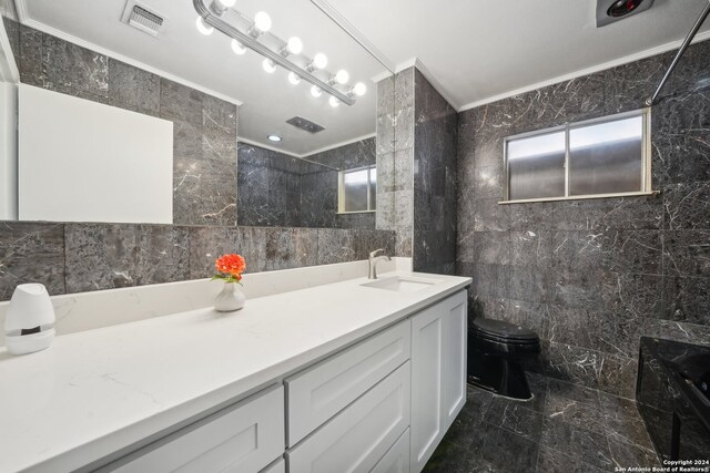 full bathroom with toilet, vanity, tile patterned flooring, and tile walls