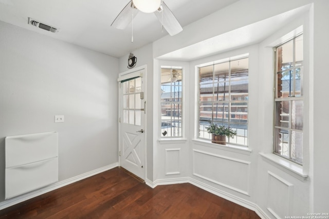 doorway with ceiling fan and wood-type flooring