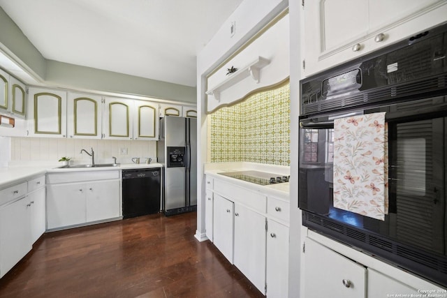 kitchen with black appliances, white cabinetry, light countertops, and a sink