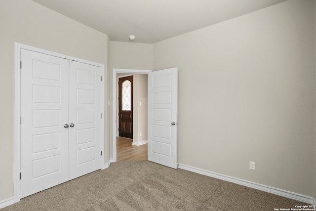 unfurnished bedroom featuring a closet and carpet floors