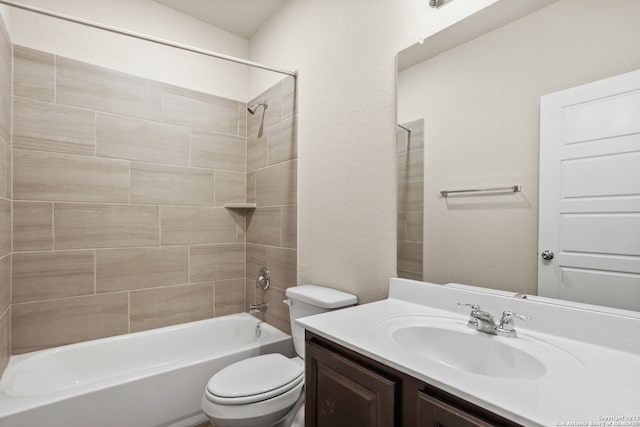 full bathroom featuring toilet, vanity, and tiled shower / bath