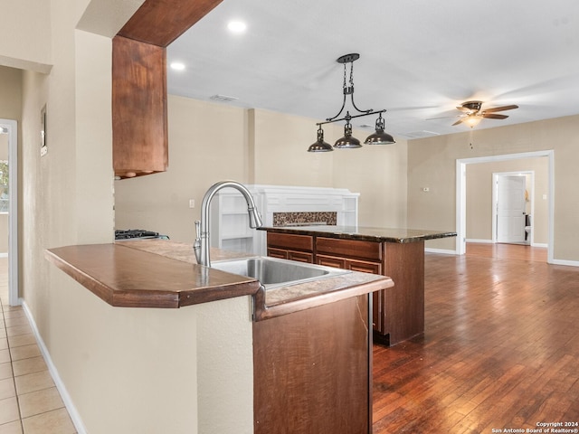 kitchen with decorative light fixtures, sink, ceiling fan, and dark hardwood / wood-style floors