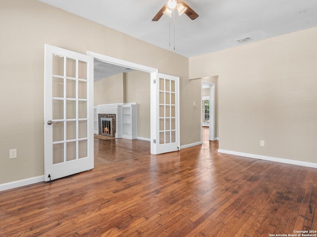 unfurnished room with french doors, wood-type flooring, and ceiling fan