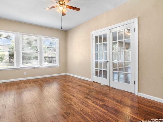 empty room with hardwood / wood-style floors, ceiling fan, and french doors