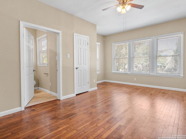 unfurnished bedroom with hardwood / wood-style floors and ceiling fan