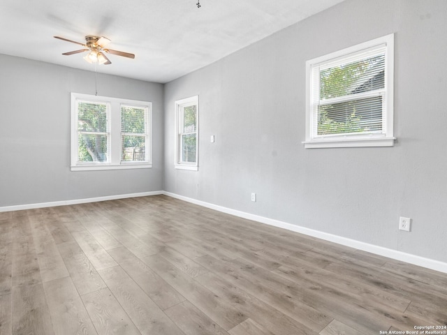 empty room featuring hardwood / wood-style floors and ceiling fan