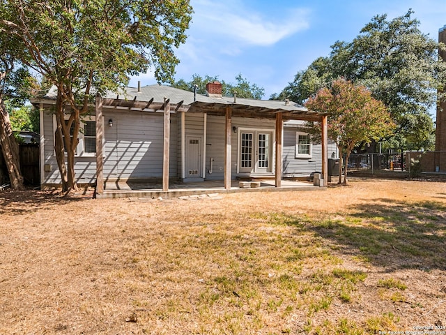 back of property featuring a lawn and a patio area