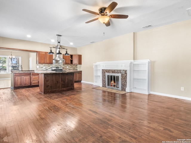 unfurnished living room featuring ceiling fan, sink, and dark hardwood / wood-style flooring