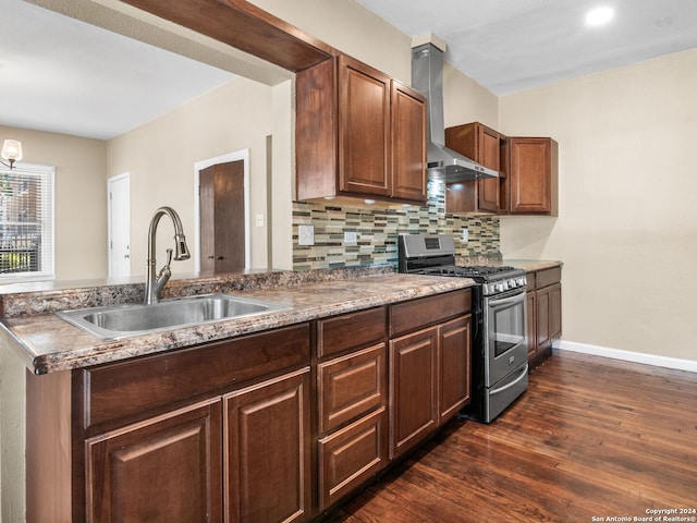 kitchen featuring tasteful backsplash, dark wood-type flooring, sink, stainless steel range with gas cooktop, and wall chimney range hood