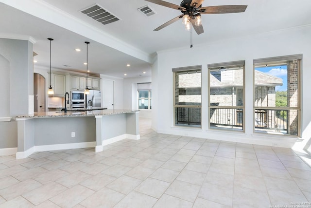 kitchen with crown molding, appliances with stainless steel finishes, hanging light fixtures, light stone countertops, and kitchen peninsula