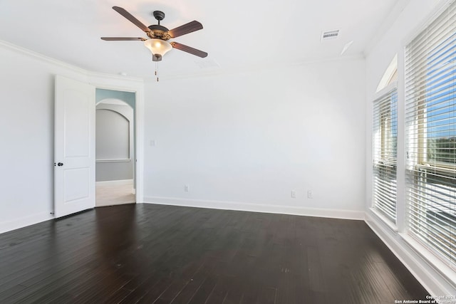 empty room featuring crown molding, ceiling fan, and dark hardwood / wood-style floors