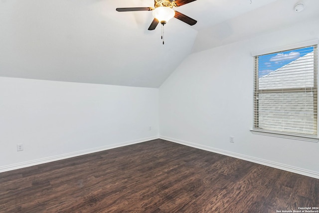 additional living space with ceiling fan, lofted ceiling, and dark hardwood / wood-style flooring