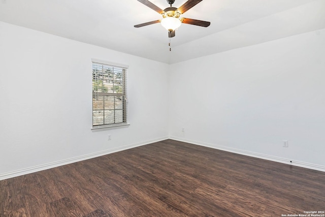 unfurnished room featuring ceiling fan and dark hardwood / wood-style flooring