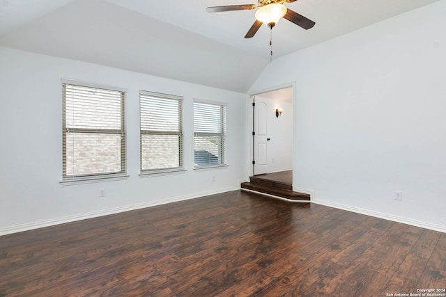 empty room with vaulted ceiling, dark hardwood / wood-style floors, and ceiling fan