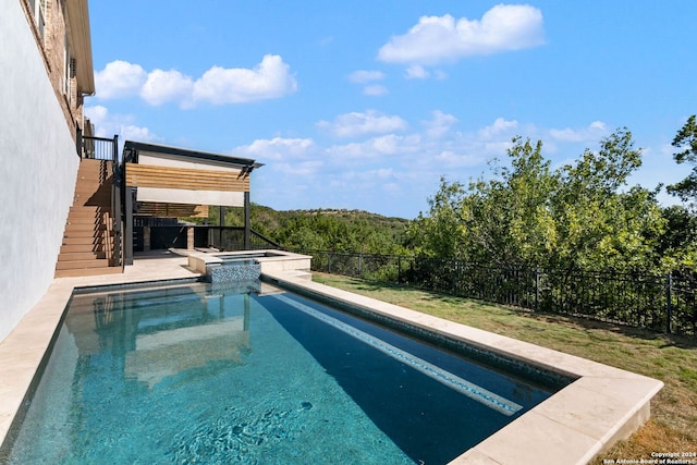 view of pool featuring an in ground hot tub