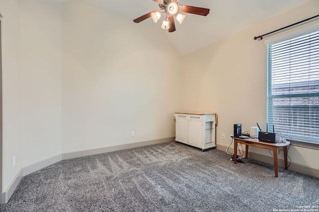 empty room with carpet floors, vaulted ceiling, and ceiling fan