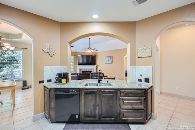 kitchen featuring light stone counters, dark brown cabinetry, sink, light tile patterned floors, and black dishwasher