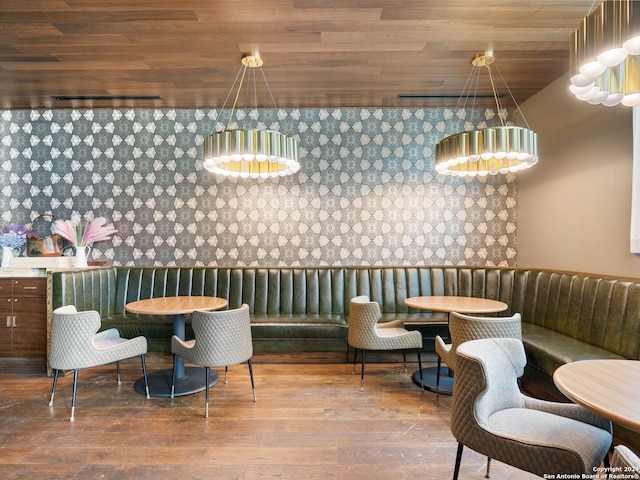 dining room featuring wood ceiling, wood-type flooring, and a chandelier