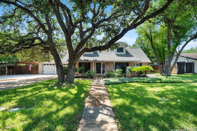 view of front of house with a garage and a front lawn