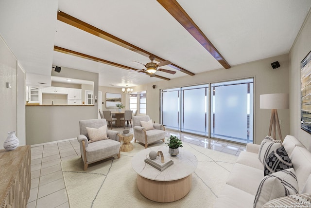 tiled living room with beam ceiling and ceiling fan with notable chandelier