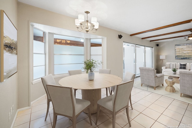 dining area featuring ceiling fan with notable chandelier, baseboards, beamed ceiling, and light tile patterned flooring