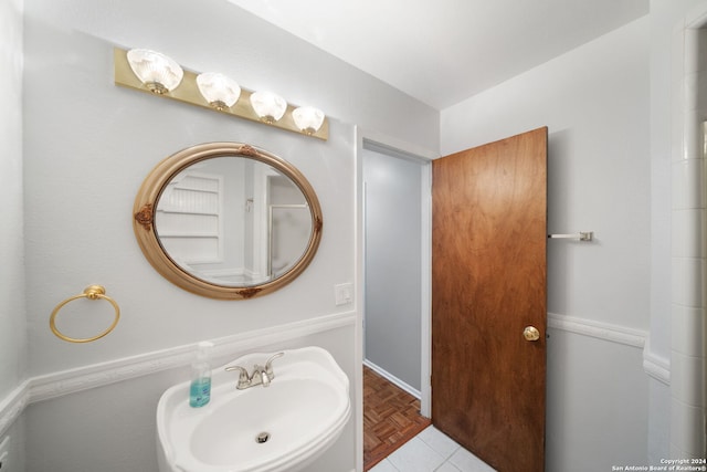 bathroom featuring sink and parquet flooring