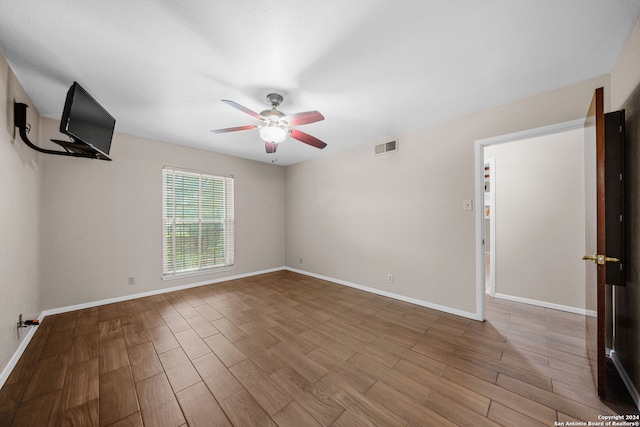 spare room featuring hardwood / wood-style floors and ceiling fan